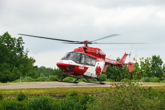 DRF Air Rescue helicopter taking off, red and white livery, emergency medical operations in Germany. Editorial use only.