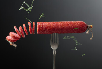 Smoked sausage on a fork.