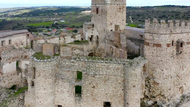 Aerial view of Belv&iacute;s de Monroy Castle, a medieval hilltop fortress ruins overlooking rural Caceres landscape, historic defensive architecture surrounded by countryside and open skies.