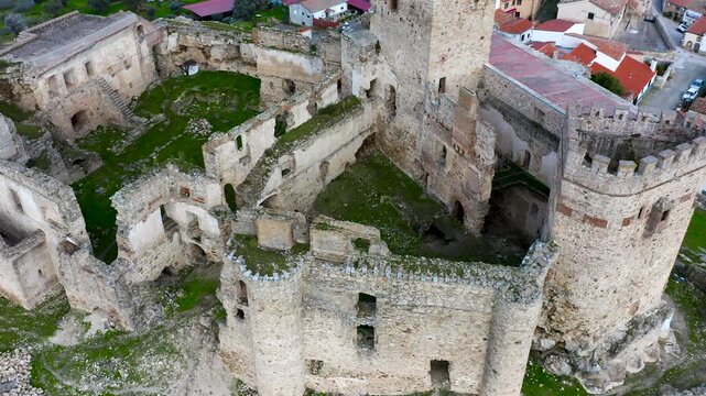 Aerial view of Belv&iacute;s de Monroy Castle, a medieval hilltop fortress ruins overlooking rural Caceres landscape, historic defensive architecture surrounded by countryside and open skies.
