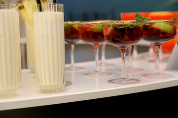 Colorful cocktails and creamy drinks on a bar counter at an event