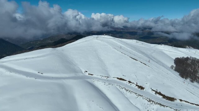 Aerial drone cinematic video of recently renovated snow center of Anilio Perched on the top of Pindus, with the comparative advantage of easy and direct access via the Egnatia Motorway, covered in sno