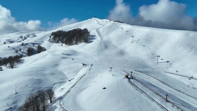 Aerial drone cinematic video of recently renovated snow center of Anilio Perched on the top of Pindus, with the comparative advantage of easy and direct access via the Egnatia Motorway, covered in sno