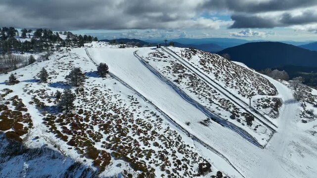 Aerial drone cinematic video of recently renovated snow center of Anilio Perched on the top of Pindus, with the comparative advantage of easy and direct access via the Egnatia Motorway, covered in sno