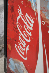 Obraz premium old busted Coca-Cola beverage refrigerator on a sidewalk in Toronto