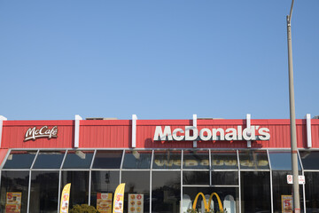 Naklejka premium exterior building and sign of McDonald's fast food restaurant at 2480 Gerrard St E (seen from Victoria Park Av), Toronto
