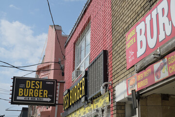 Naklejka premium projecting sign outside Desi Burger, a Pakistani restaurant, located at 1342 Gerrard St E, Toronto