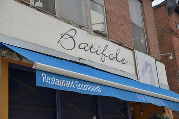Obraz premium sign and awning outside Batifole, a French restaurant, located at 744 Gerrard St E, Toronto