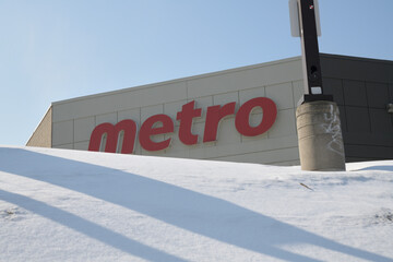Naklejka premium logo sign on the exterior of Metro, a supermarket chain, located here at 3003 Danforth Av (seen from Victoria Park Av), Toronto