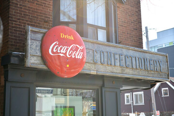 Naklejka premium vintage remnants of Jack's Variety & Grocery, metal block letters and a Coca-Cola button sign on the exterior of 1999 Gerrard St E, Toronto
