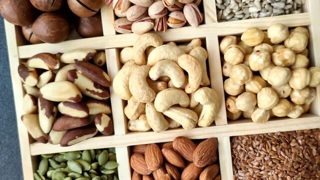A mix of cashews, pistachios, almonds, brazil nuts, macadamia and hazelnuts as healthy food ingredients. Nuts as a food background for your design