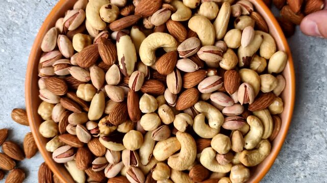 A mix of cashews, pistachios, almonds, brazil nuts, macadamia and hazelnuts as healthy food ingredients. Nuts as a food background for your design
