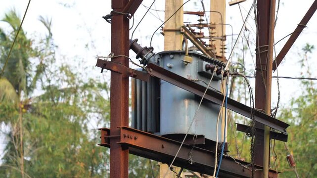 Electric Transformer on Utility Pole &ndash; Power Distribution Infrastructure. High Voltage Transformer with Power Lines &ndash; Electricity Supply Concept. Electrical Distribution Transformer Mounted on Pole.