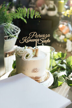 Simple, elegant cake with "Pierwsza Komunia Święta" cake topper - "first communion" in Polish