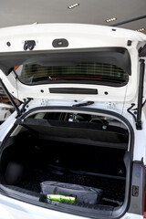 Car trunk interior with open hatchback, storage space and accessories visible
