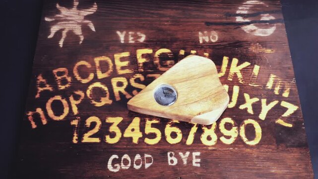 A classic original homemade talking spirit board with a planchette moving by spirits or ghosts from the afterlife, or time lapse stop motion if you want to get technical.