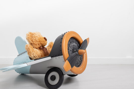 teddy bear and wooden toy airplane with world map, Travel concept. party decoration.children's toys happy birthday day. copy space. Commitment and creative growth concept