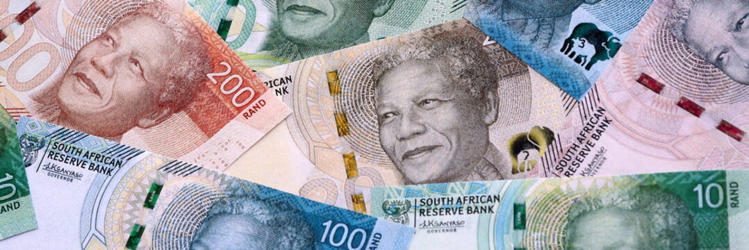 South African rand money bills pile on table. South Africa banknotes of ZAR currency close up.