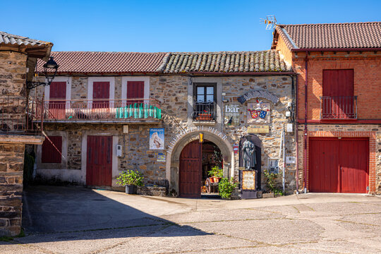 Rustic stone facade of the Albergue El Pilar hostel and bar in the village of Rabanal del Camino, a traditional rest stop for pilgrims on the Camino de Santiago trail in the mountains of Spain.