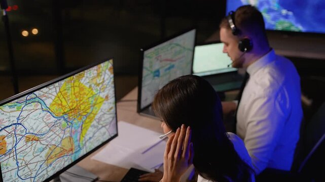 Logistics dispatcher team working at night coordinating cargo delivery