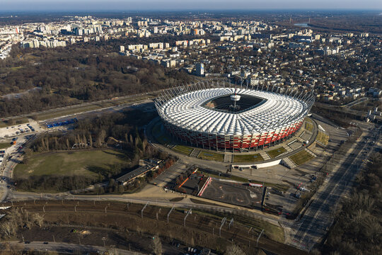 Aerial of PGE Narodowy in Warsaw beside Vistula parks and rails