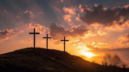Obraz premium Tranquil Sunset with Three Crosses Silhouetted Against Vibrant Sky