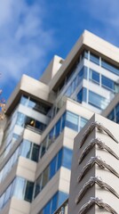 Modern building facade with geometric design against blue sky