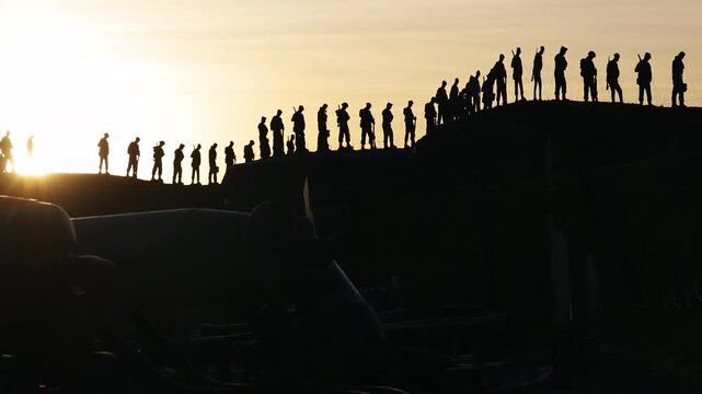 Soldier Silhouettes Standing Guard at Sunset