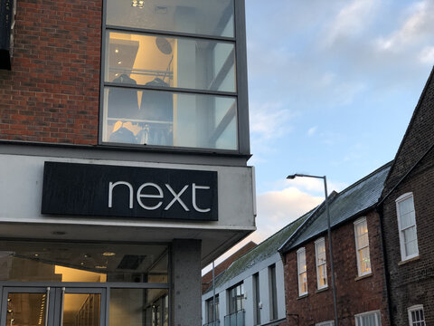 Corner of NEXT outlet shop at sundown. Boston Lincs. UK. Feb. 2026