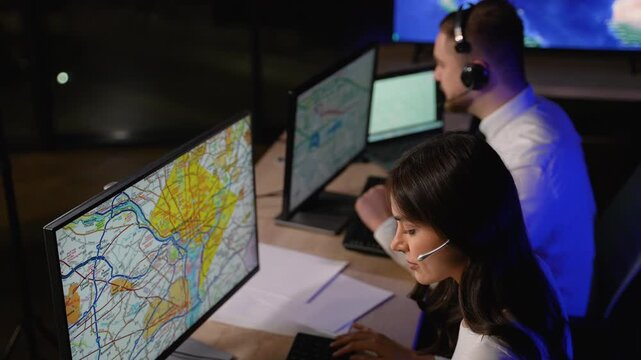 Transport dispatchers coordinating cargo delivery on computer map