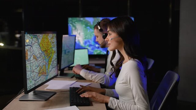 Transport dispatcher working on computer in logistics control room