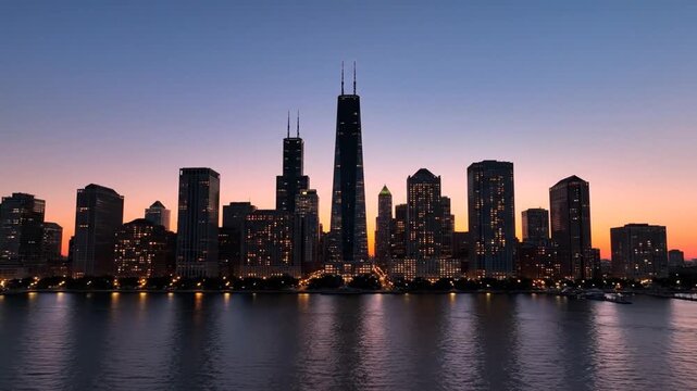 Chicago skyline at sunset over Lake Michigan with city lights