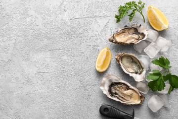 Delicious fresh oysters with lemon, parsley and ice cubes on grey background © Pixel-Shot