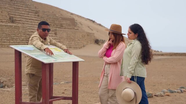Tour guide explaining history at bandurria archaeological site in peru