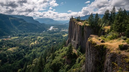 Obraz premium Towering cliff overlooking verdant valley and winding river under cloudy sky rock forest