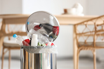 Full trash bin in modern kitchen, closeup © Pixel-Shot