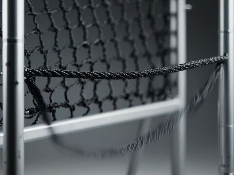 Rebounder Net Detail. Football Training Equipment Mockup (Functional & Educational). Functional Mockup. A close-up of a black bungee-cord tensioned on a rebounder net frame, set in a minimalist studio