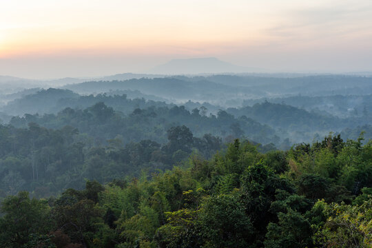 Nam Nao National Park at sunrise. Misty morning light over lush green forest. Tropical jungle landscape in Thailand.