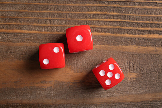 Red dices on wooden background