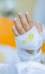 Kid patients have IV tube child's hand Children's patient in the hospital with saline intravenous (iv) was punctured with an IV needle by a doctor