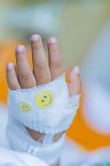 Kid patients have IV tube child's hand Children's patient in the hospital with saline intravenous (iv) was punctured with an IV needle by a doctor