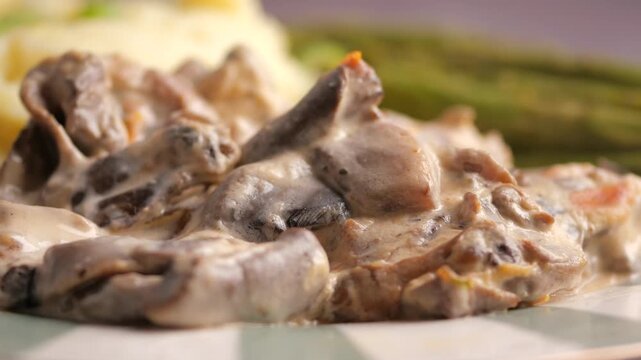 Close-Up of Creamy Mushroom Stroganoff with Mashed Potatoes and Asparagus