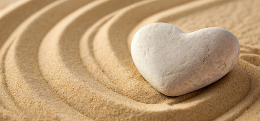 A heart-shaped stone resting peacefully in textured sand, evoking tranquility and serenity. The stone symbolizes love, peace, and natural beauty