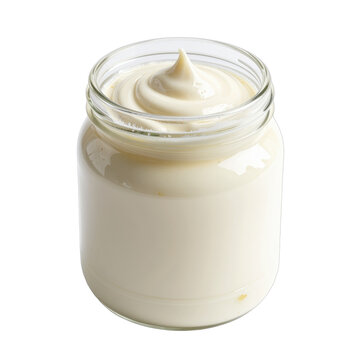 A glass jar filled with creamy white mayonnaise with a peak swirled on top