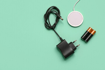 Different chargers and batteries on turquoise background. Concept of evolution