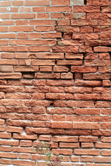 Fototapeta premium An old weathered, clay brick wall with visible texture, imperfections, weathering etc