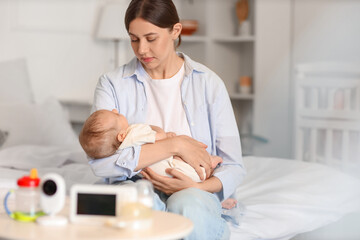 Fototapeta premium Mother with her little baby sitting in bedroom