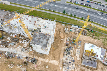 building new apartment blocks in residential area. aerial top view of city construction site.