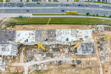 new multistory apartment building under construction. aerial top view of busy construction site in city residential area.