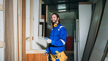 Professional Woodworker Measuring, Cutting and Installing Timber in Factory. Carpentry and Wood Manufacturing Process in Industrial Workshop